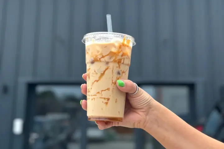 A hand-held iced coffee from The Café