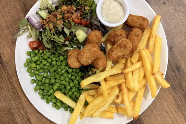 A plate of chips and salad at The Café